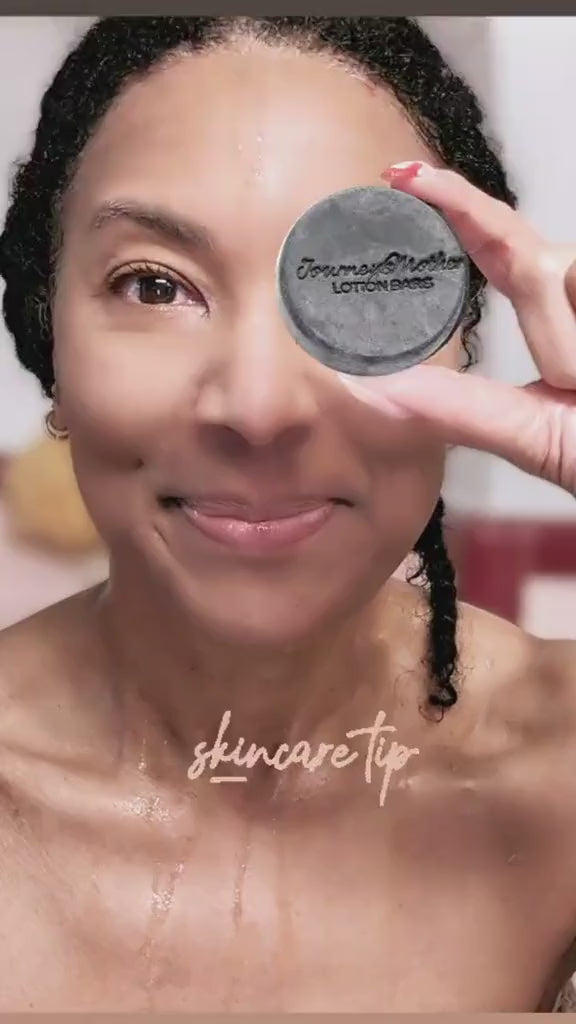 Journey's Mother using ALOHA bar soap to was face and underarms while smiling in the bathroom.